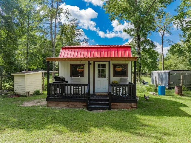 a view of a house with a yard porch and sitting area