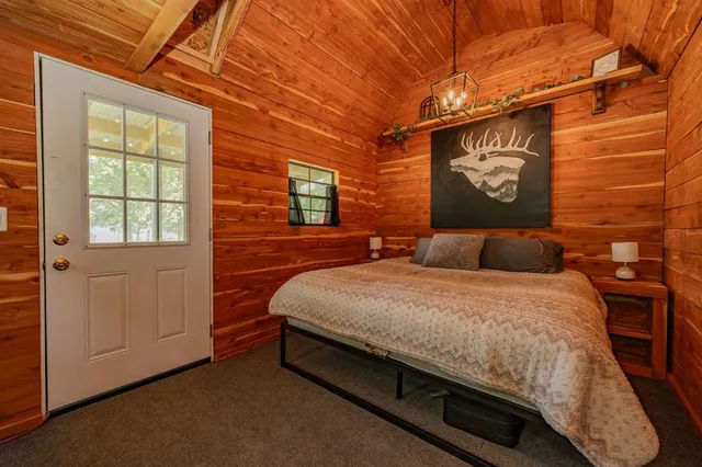 a bed sitting in a room next to a window