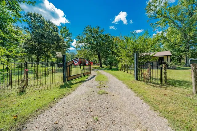 a view of a park with iron fence