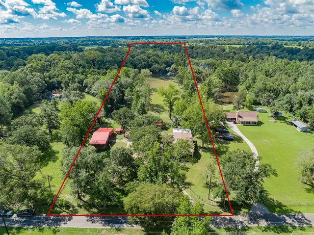 an aerial view of a house with a yard