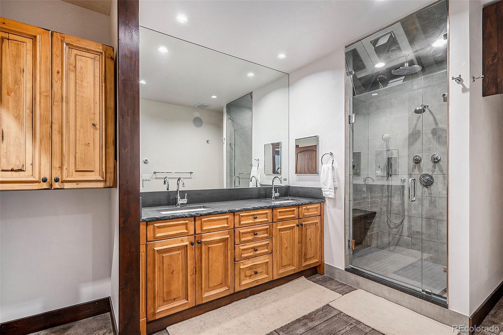 602 Spruce Street Red Cliff, CO 81649 - Photo 19 of 44 a bathroom with a granite countertop sink mirror and shower