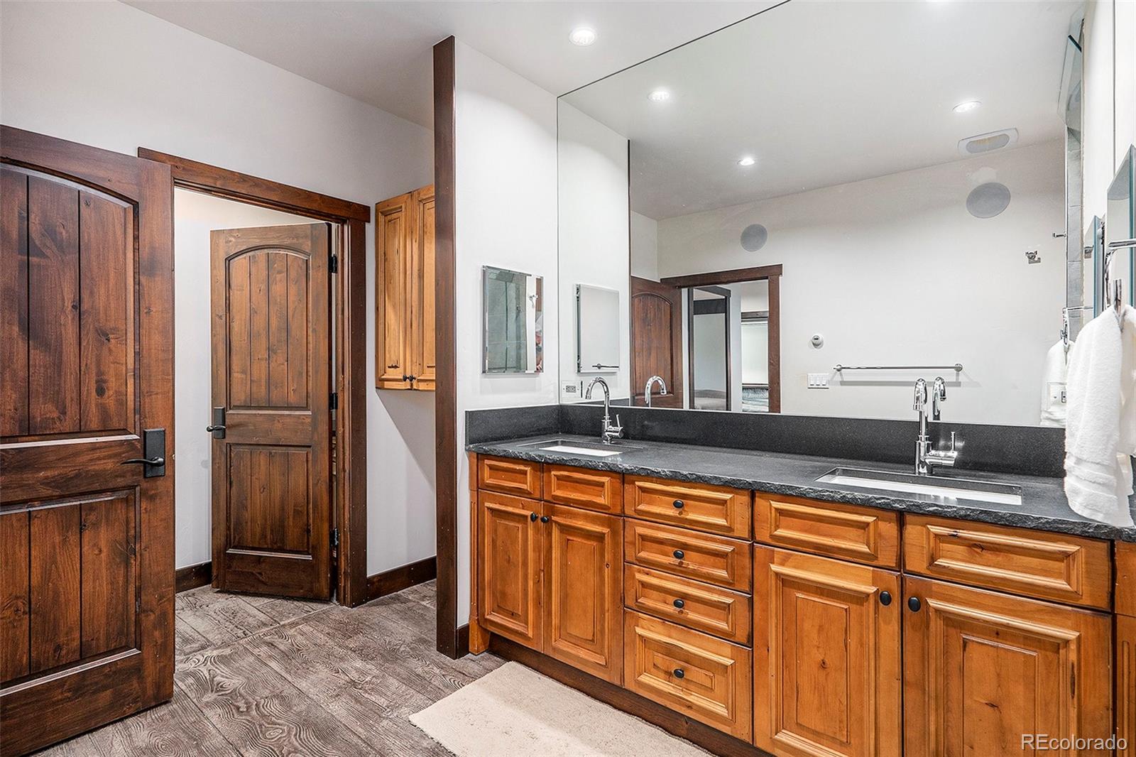 602 Spruce Street Red Cliff, CO 81649 - Photo 20 of 44 a spacious bathroom with a granite countertop sink and a mirror