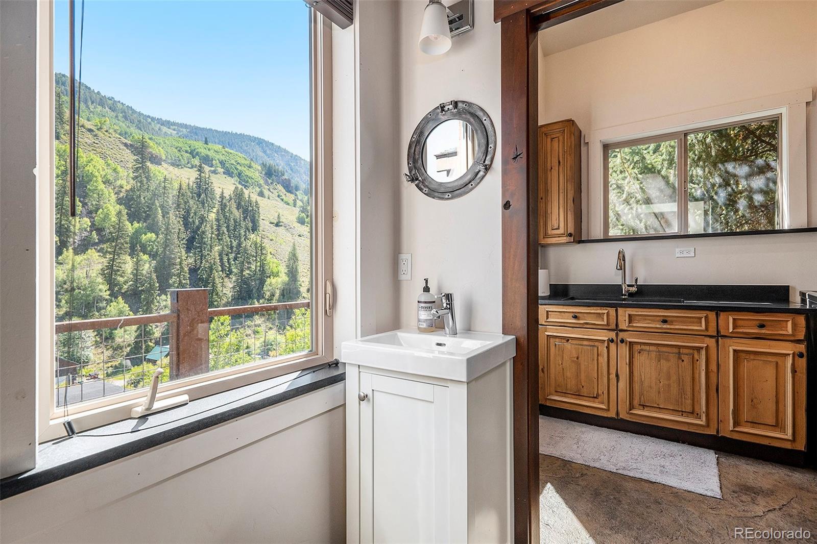 602 Spruce Street Red Cliff, CO 81649 - Photo 27 of 44 a bathroom with a sink and a large window