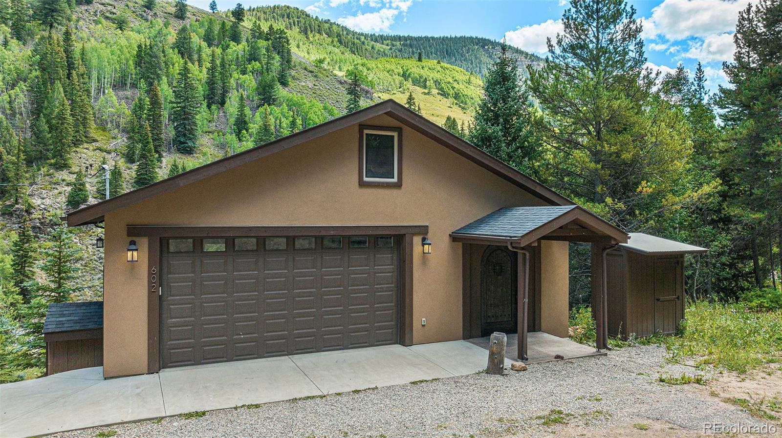 602 Spruce Street Red Cliff, CO 81649 - Photo 31 of 44 a front view of a house with a yard and garage
