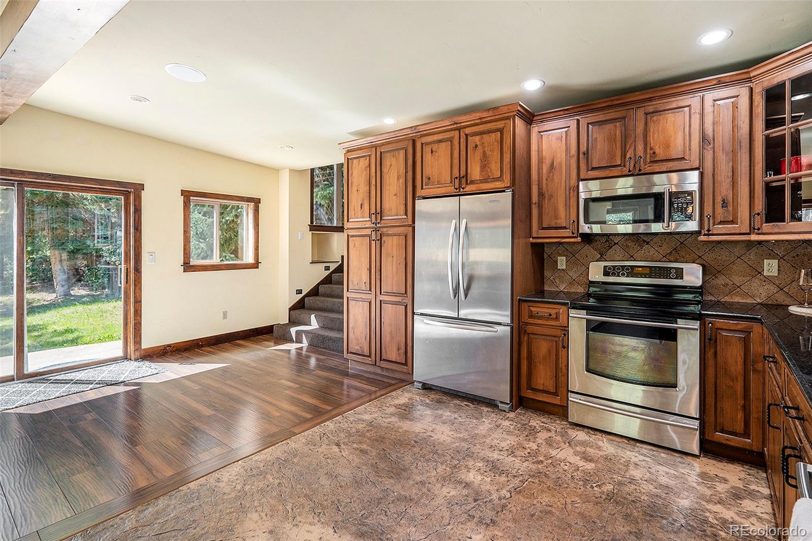 602 Spruce Street Red Cliff, CO 81649 - Photo 7 of 44 a kitchen with stainless steel appliances granite countertop a refrigerator stove and sink