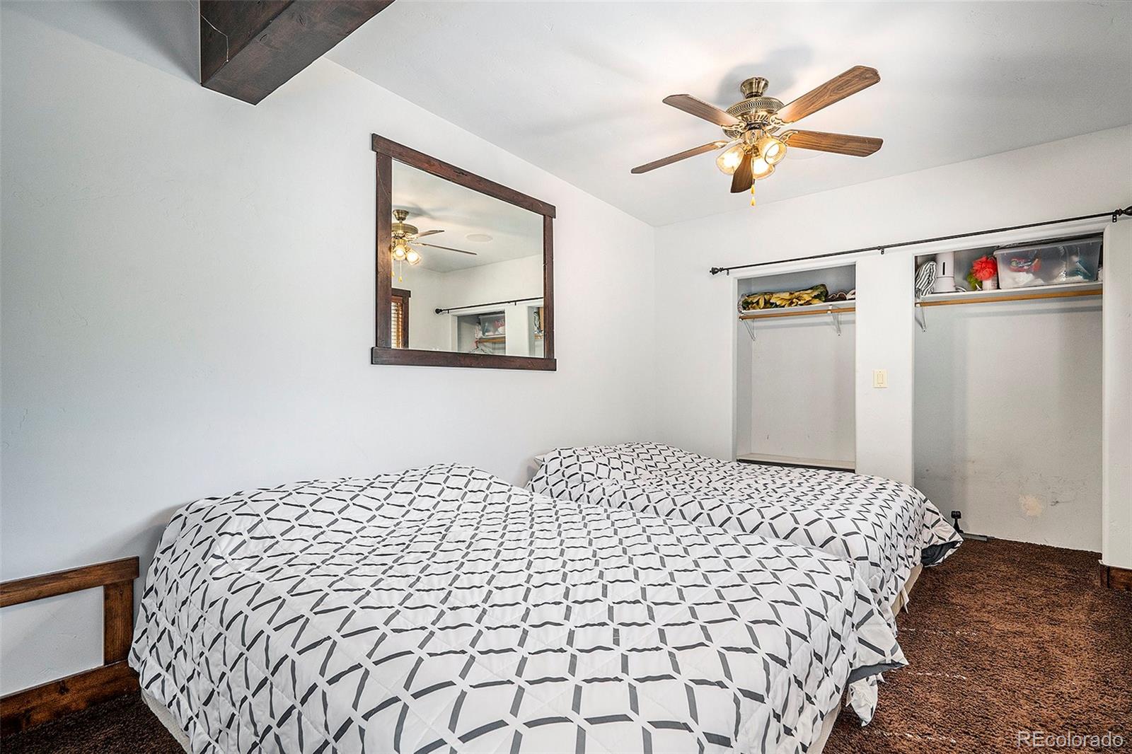 602 Spruce Street Red Cliff, CO 81649 - Photo 10 of 44 a bedroom with a bed and a painting on the wall