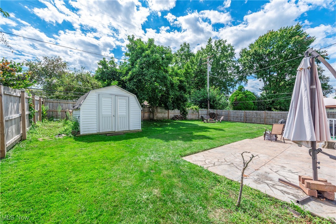 13765 Newton Road Cleveland, OH 44130 - Photo 36 of 42 Fenced backyard with a patio and a storage shed