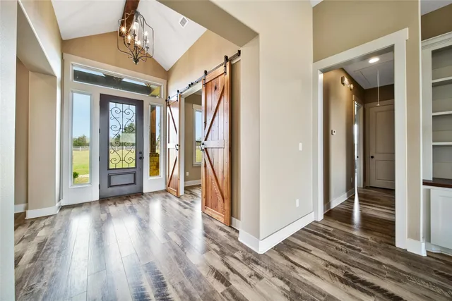 a view of a room with wooden floor and stairs