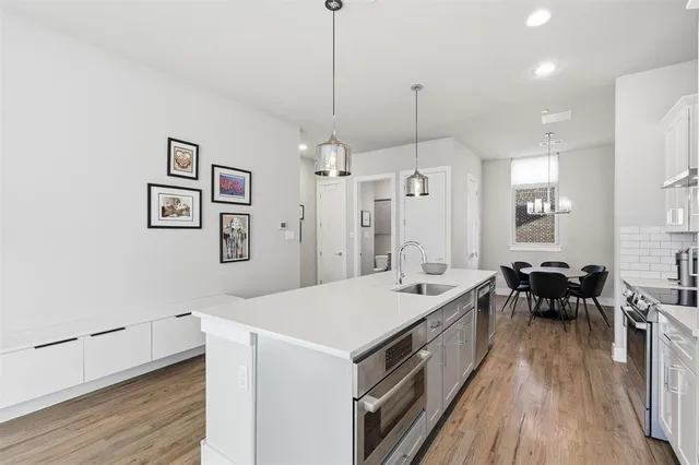 a view of a dining room with furniture wooden floor and a chandelier