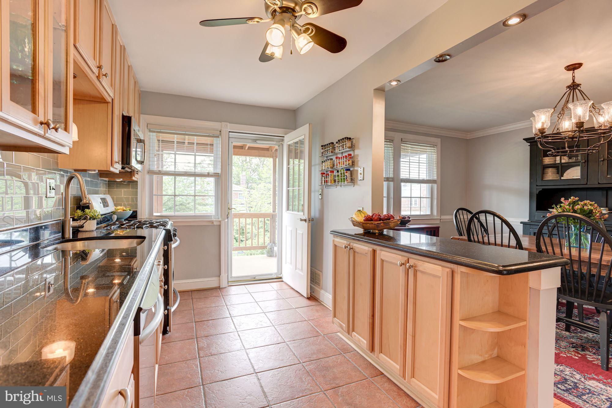 417 Whitfield Road Baltimore, MD 21228 - Photo 2 of 31 a kitchen with granite countertop a stove and a sink