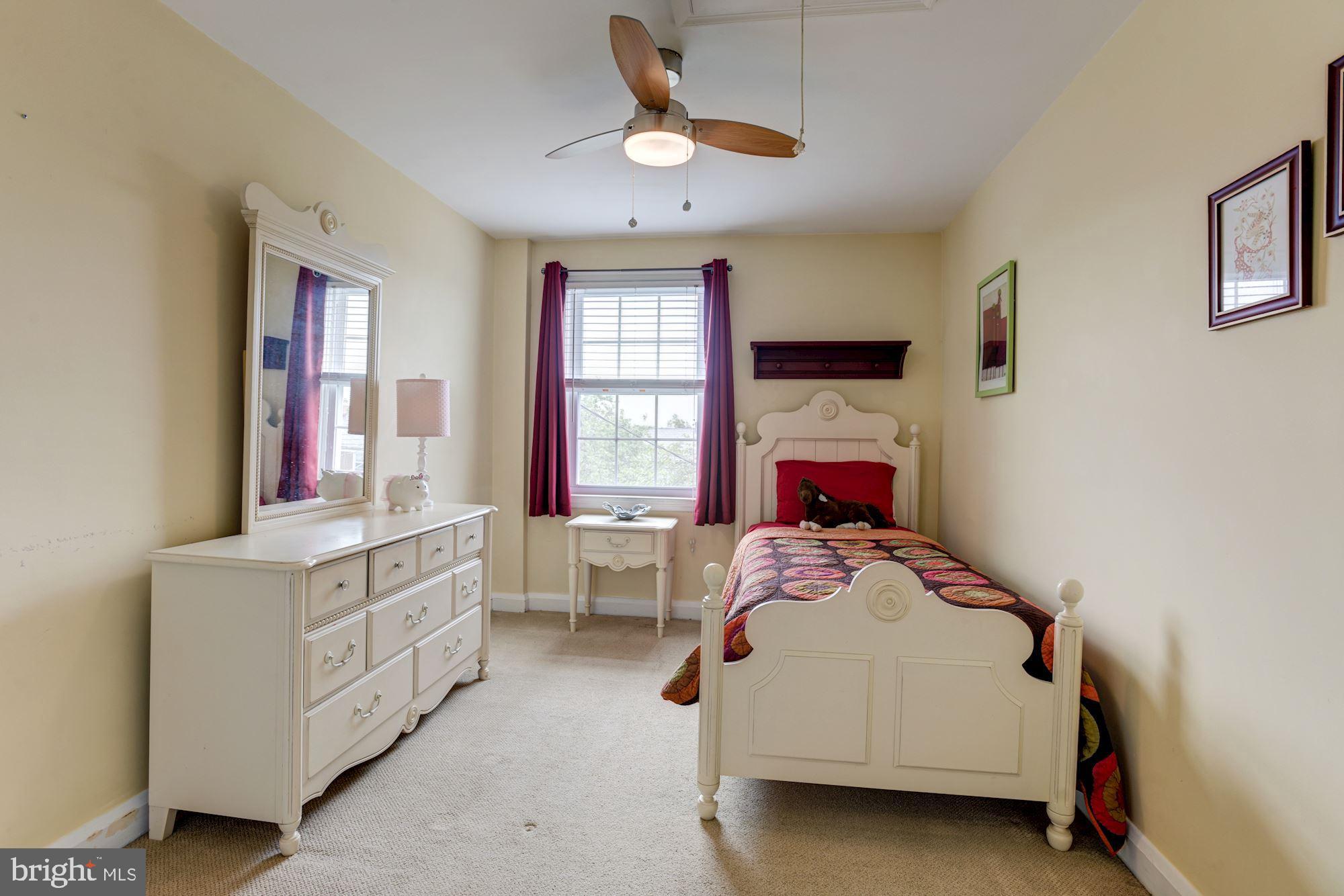 417 Whitfield Road Baltimore, MD 21228 - Photo 21 of 31 a bedroom with a bed a window and dresser