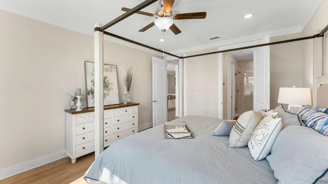 a spacious bedroom with a bed and a chandelier