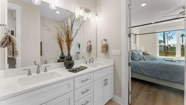 a bathroom with double vanity sink a mirror and a shower