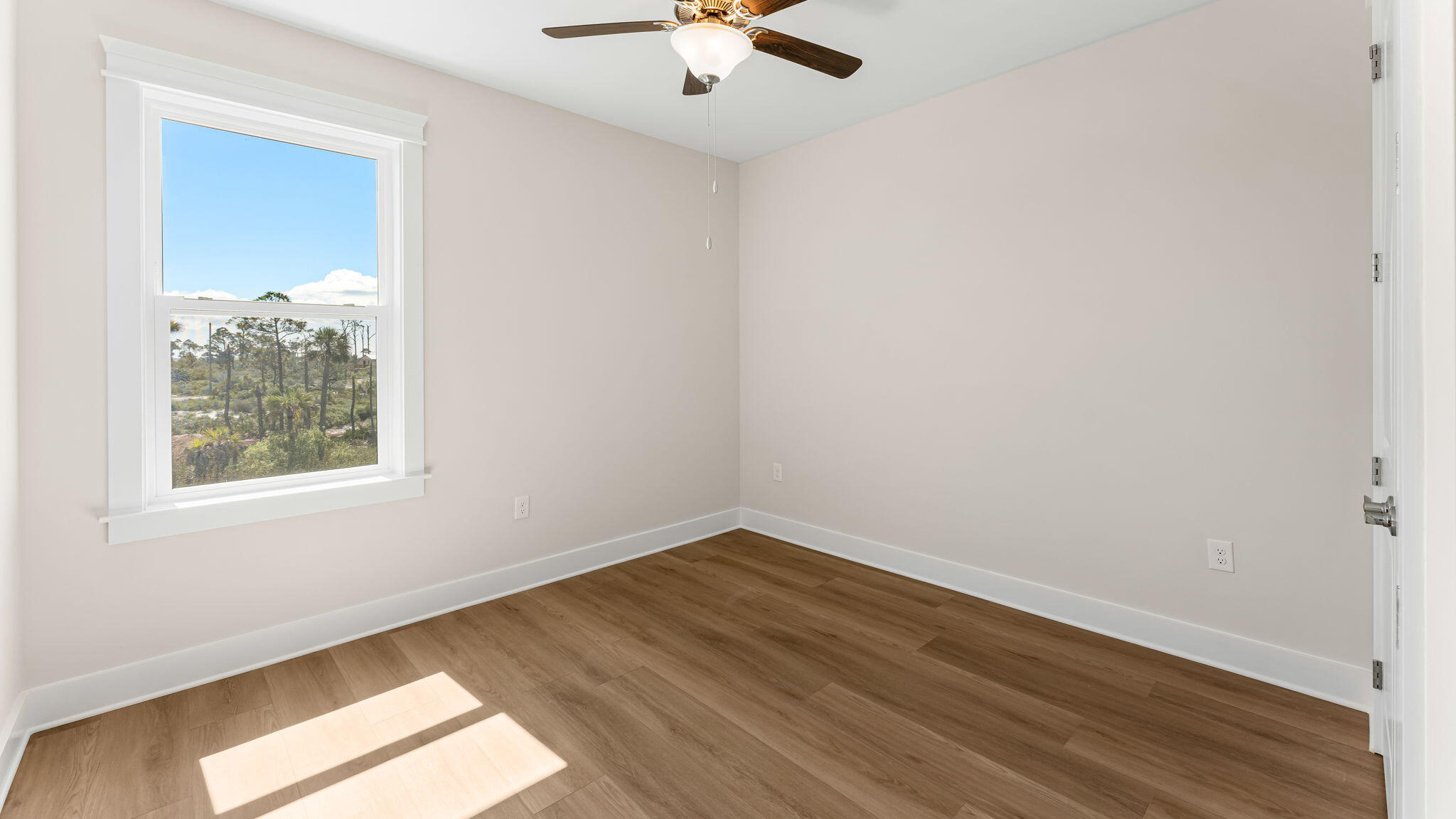 123 Marsh View Ridge Ln Cape Port St. Joe, FL 32456 - Photo 26 of 34 an empty room with wooden floor and windows