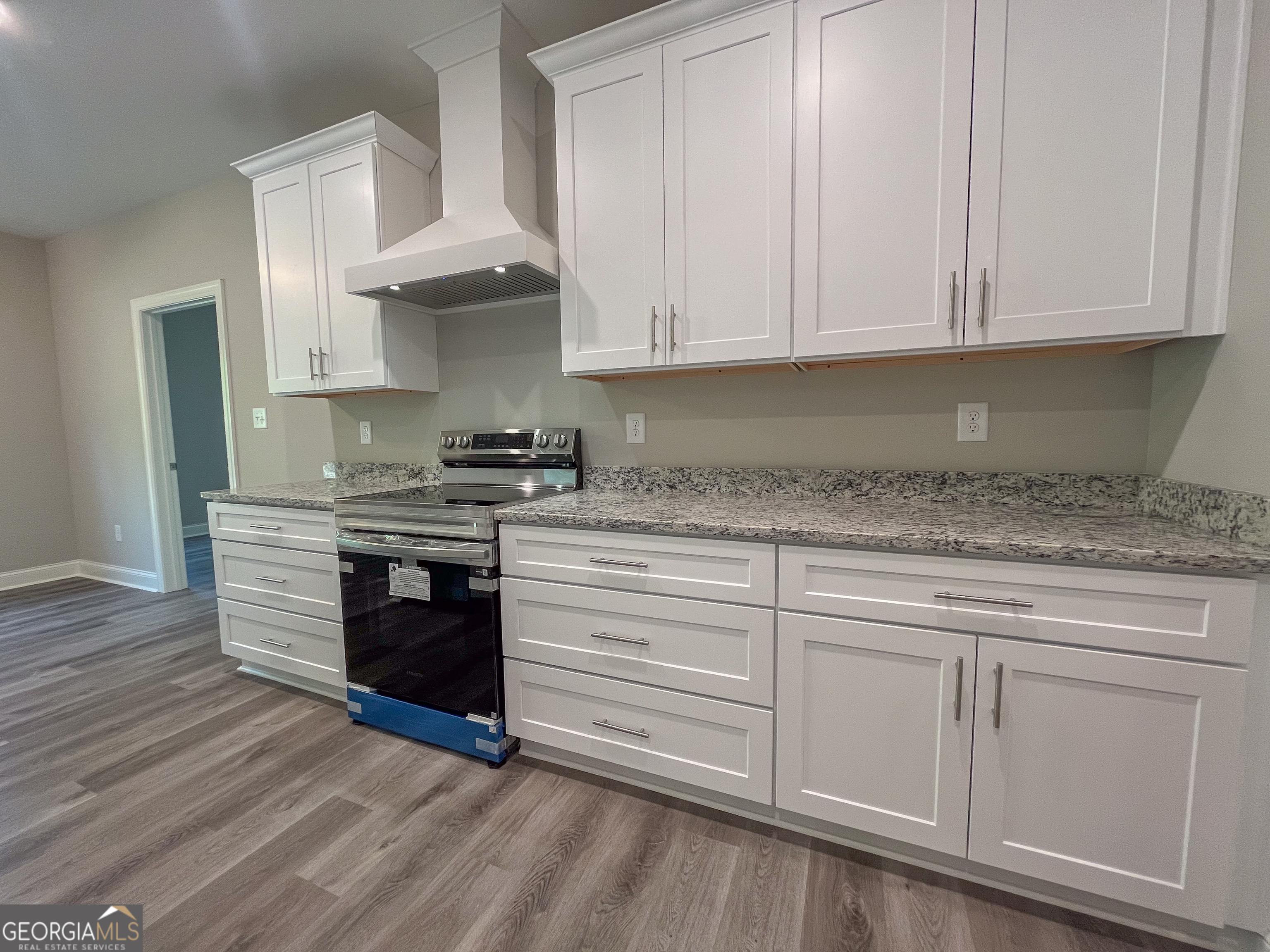 711 Flanders Lane Dublin, GA 31021 - Photo 14 of 49 a kitchen with granite countertop white cabinets and stainless steel appliances