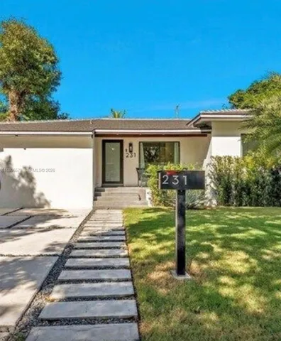a front view of a house with garden