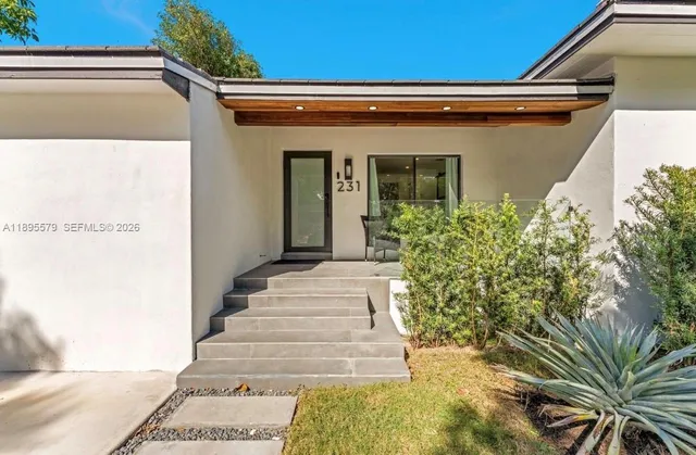 a front view of a house with garden