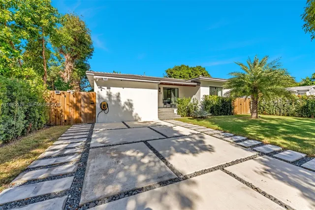 a front view of a house with a garden
