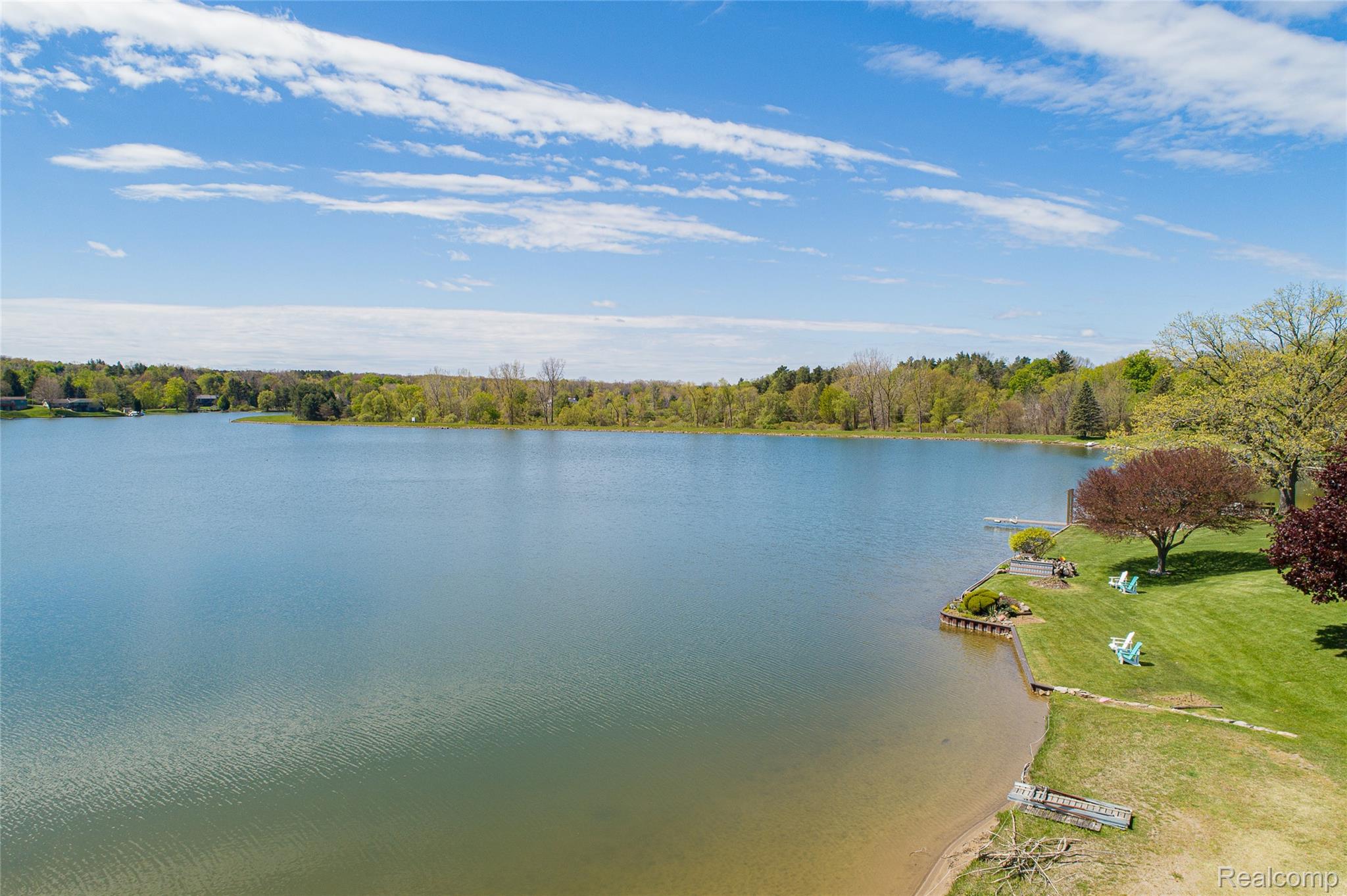 2855 Farmers Creek Road Metamora, MI 48455 - Photo 48 of 51 Lakeside property featuring a sandy shoreline with a small dock and lush green lawn