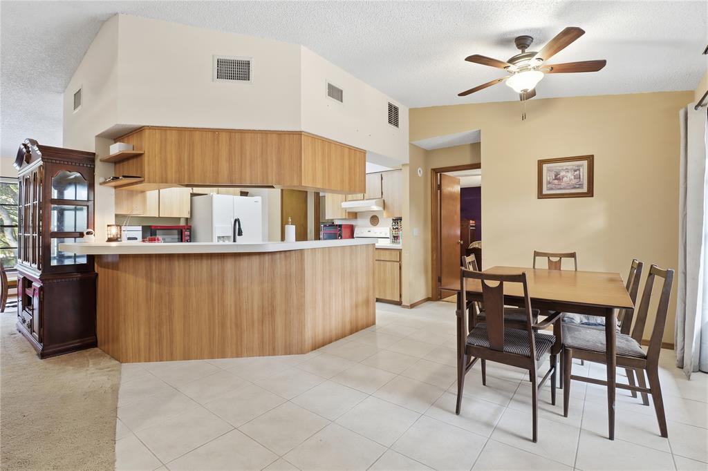 3050 East Possum Court Inverness, FL 34452 - Photo 11 of 65 a kitchen with a table chairs and a refrigerator