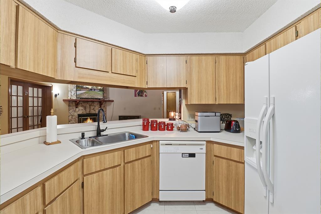 3050 East Possum Court Inverness, FL 34452 - Photo 13 of 65 a kitchen with a sink cabinets stainless steel appliances and a window