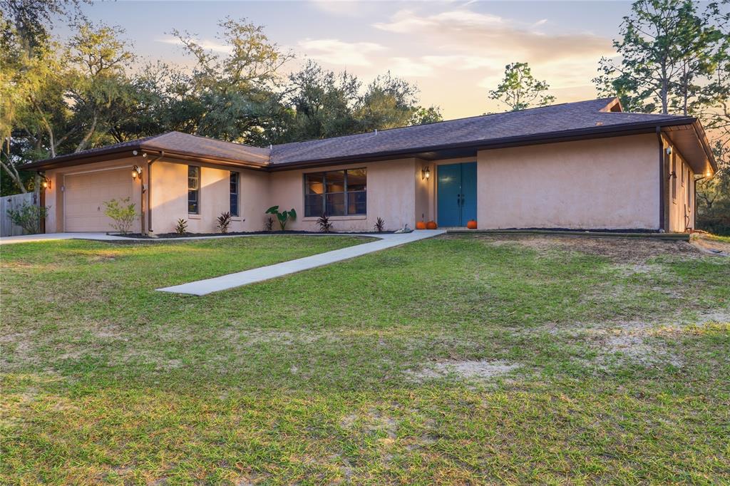 3050 East Possum Court Inverness, FL 34452 - Photo 2 of 65 a front view of house with yard and trees