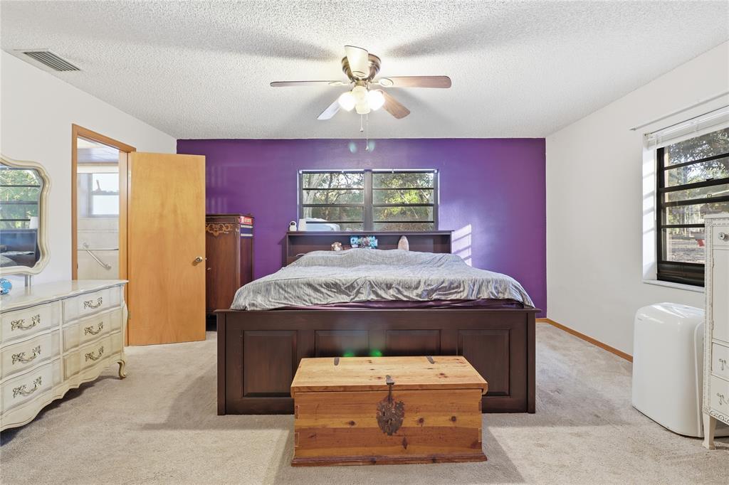 3050 East Possum Court Inverness, FL 34452 - Photo 21 of 65 a bed sitting in a room next to a window