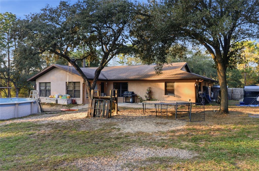 3050 East Possum Court Inverness, FL 34452 - Photo 32 of 65 a view of a house with backyard and a tree