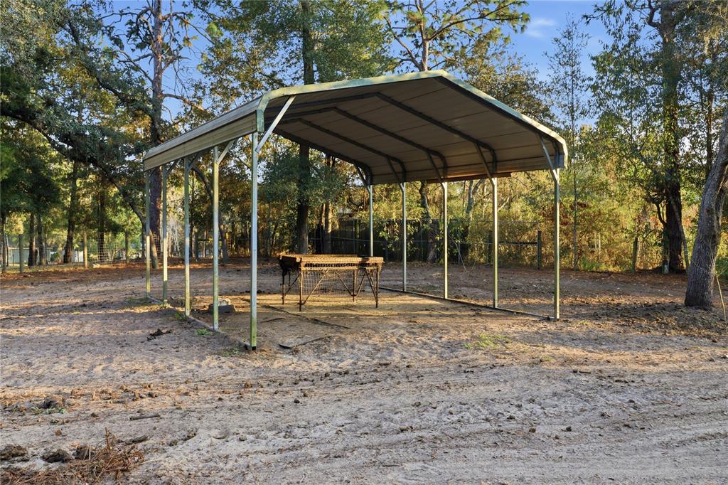 3050 East Possum Court Inverness, FL 34452 - Photo 35 of 65 a backyard of a house with table and chairs