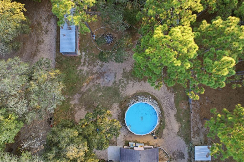 3050 East Possum Court Inverness, FL 34452 - Photo 38 of 65 a view of a house with a backyard and a forest