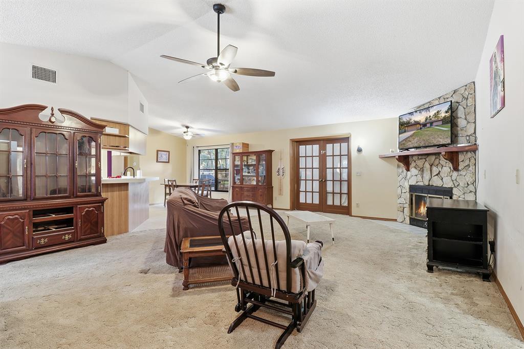 3050 East Possum Court Inverness, FL 34452 - Photo 7 of 65 a living room with furniture and a fireplace
