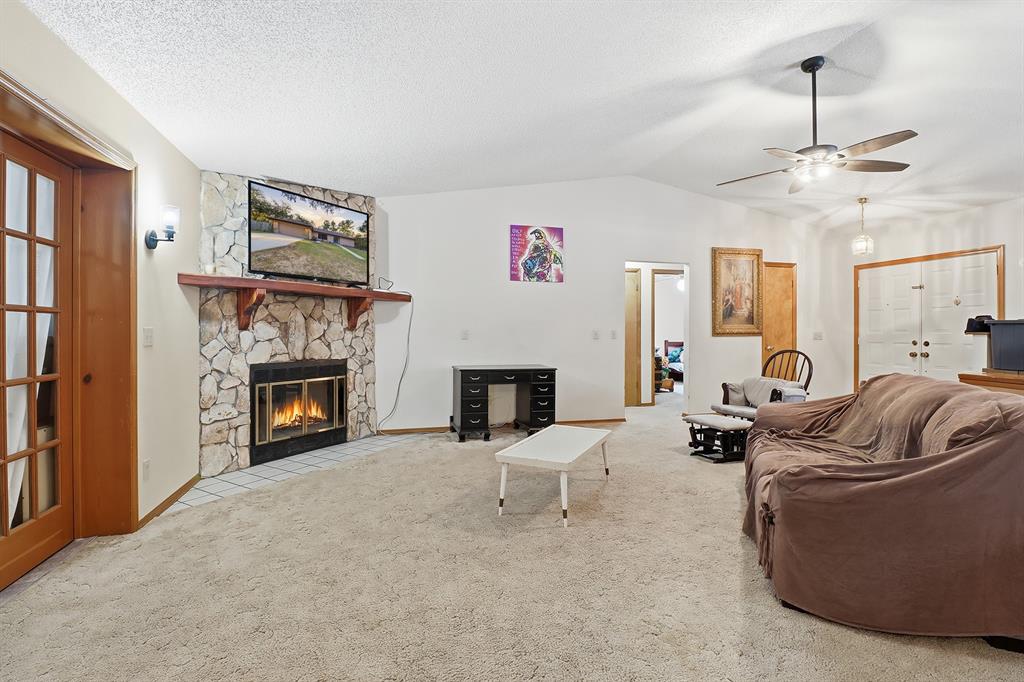 3050 East Possum Court Inverness, FL 34452 - Photo 8 of 65 a living room with furniture a fireplace and a flat screen tv