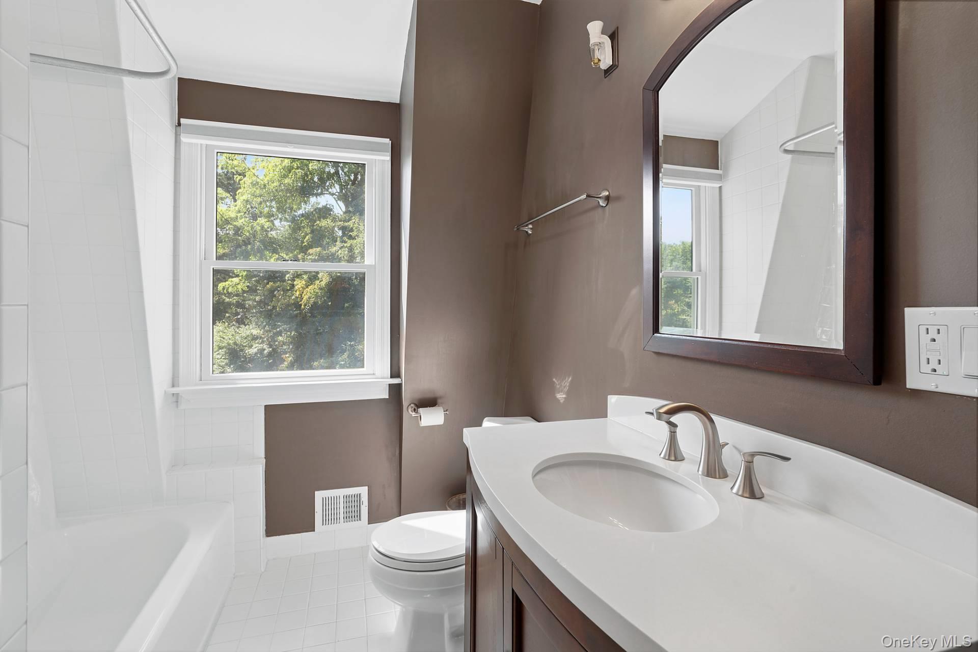 28 Plain View Drive Wading River, NY 11792 - Photo 15 of 20 a bathroom with a toilet sink and mirror