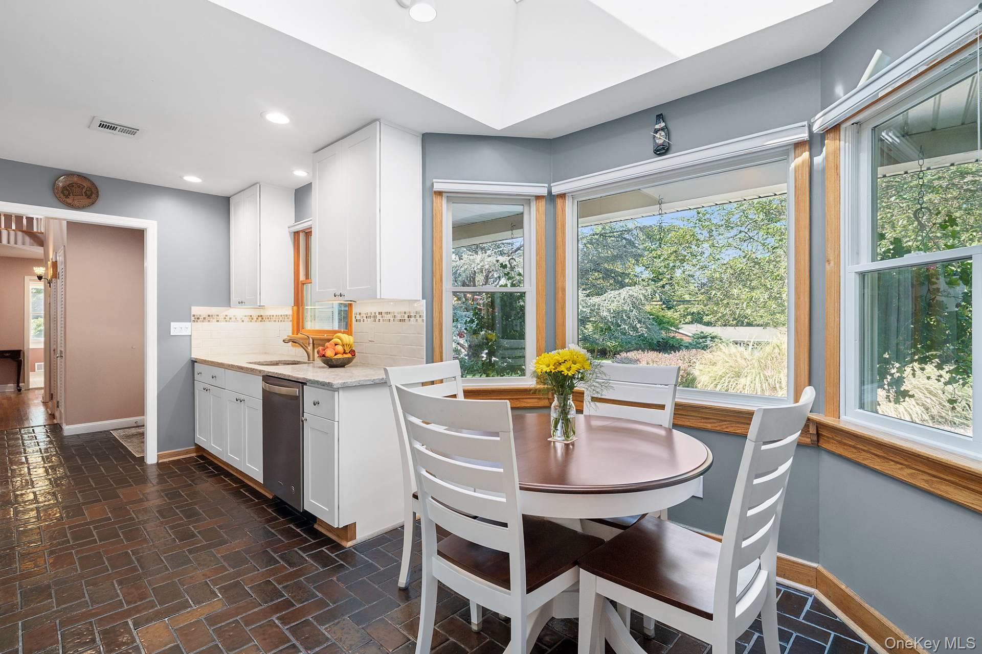 28 Plain View Drive Wading River, NY 11792 - Photo 3 of 20 a kitchen with a table chairs stove and refrigerator