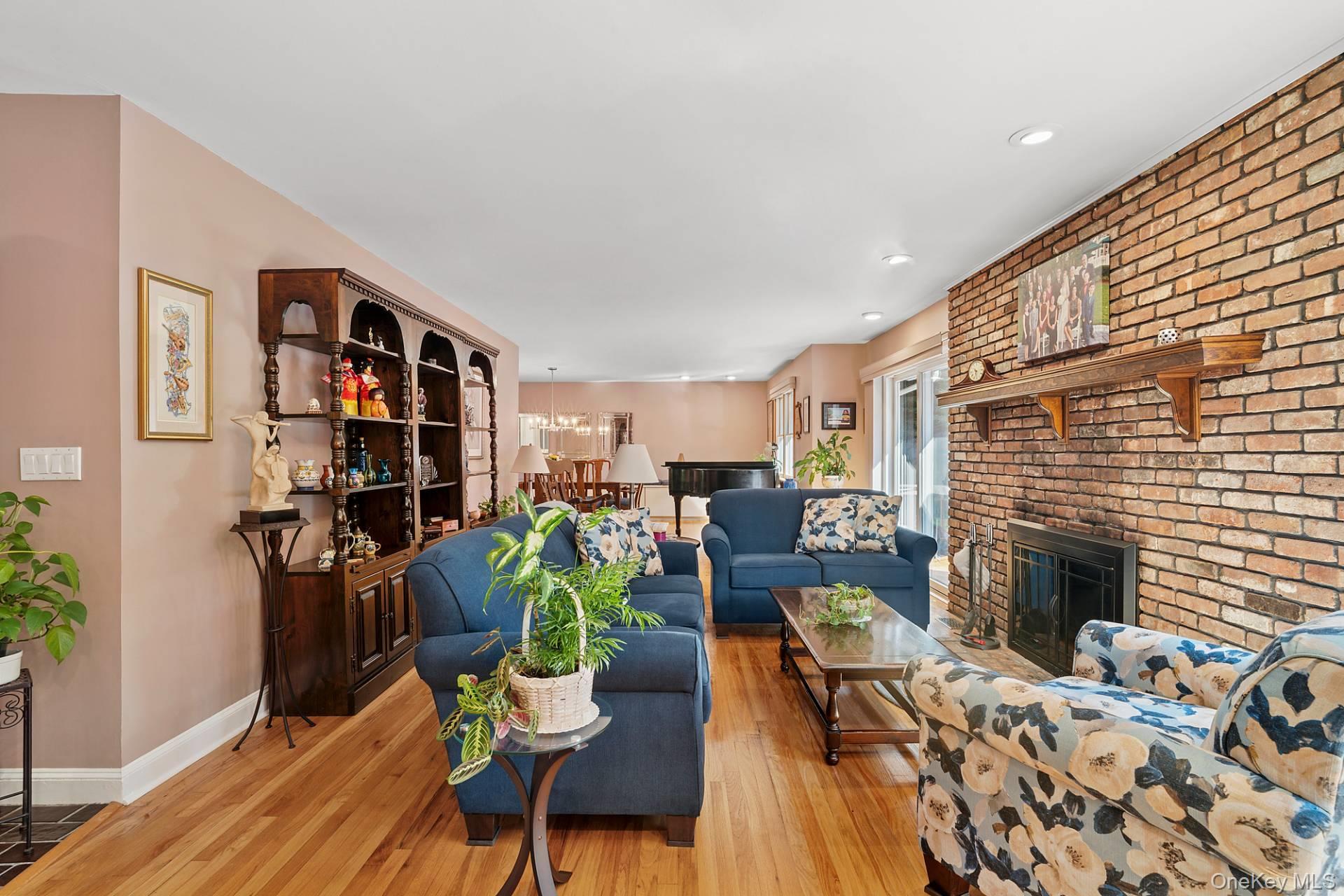 28 Plain View Drive Wading River, NY 11792 - Photo 5 of 20 a living room with fireplace furniture and a book shelf