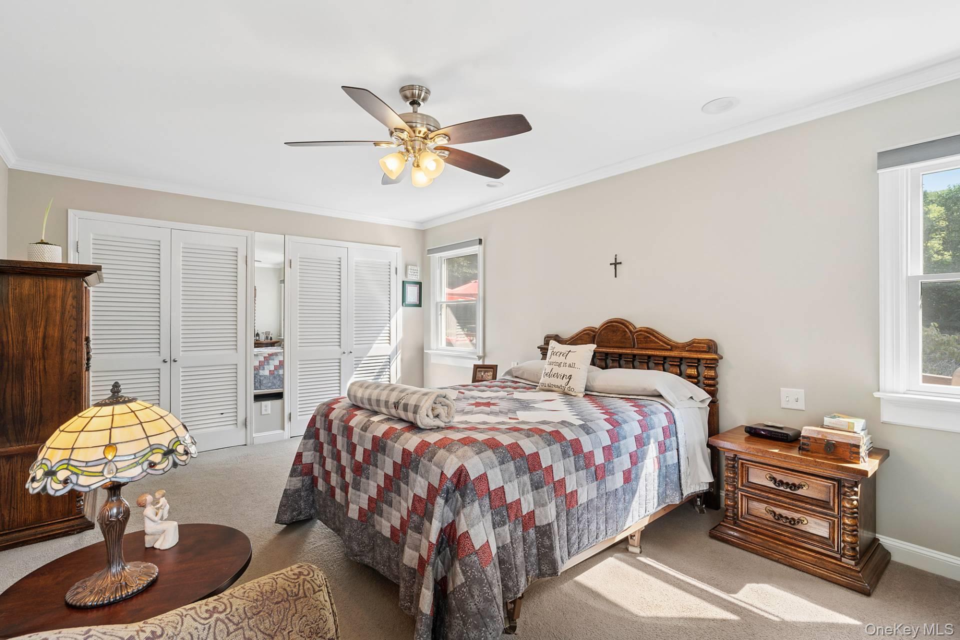 28 Plain View Drive Wading River, NY 11792 - Photo 6 of 20 a bedroom with two beds and chandelier