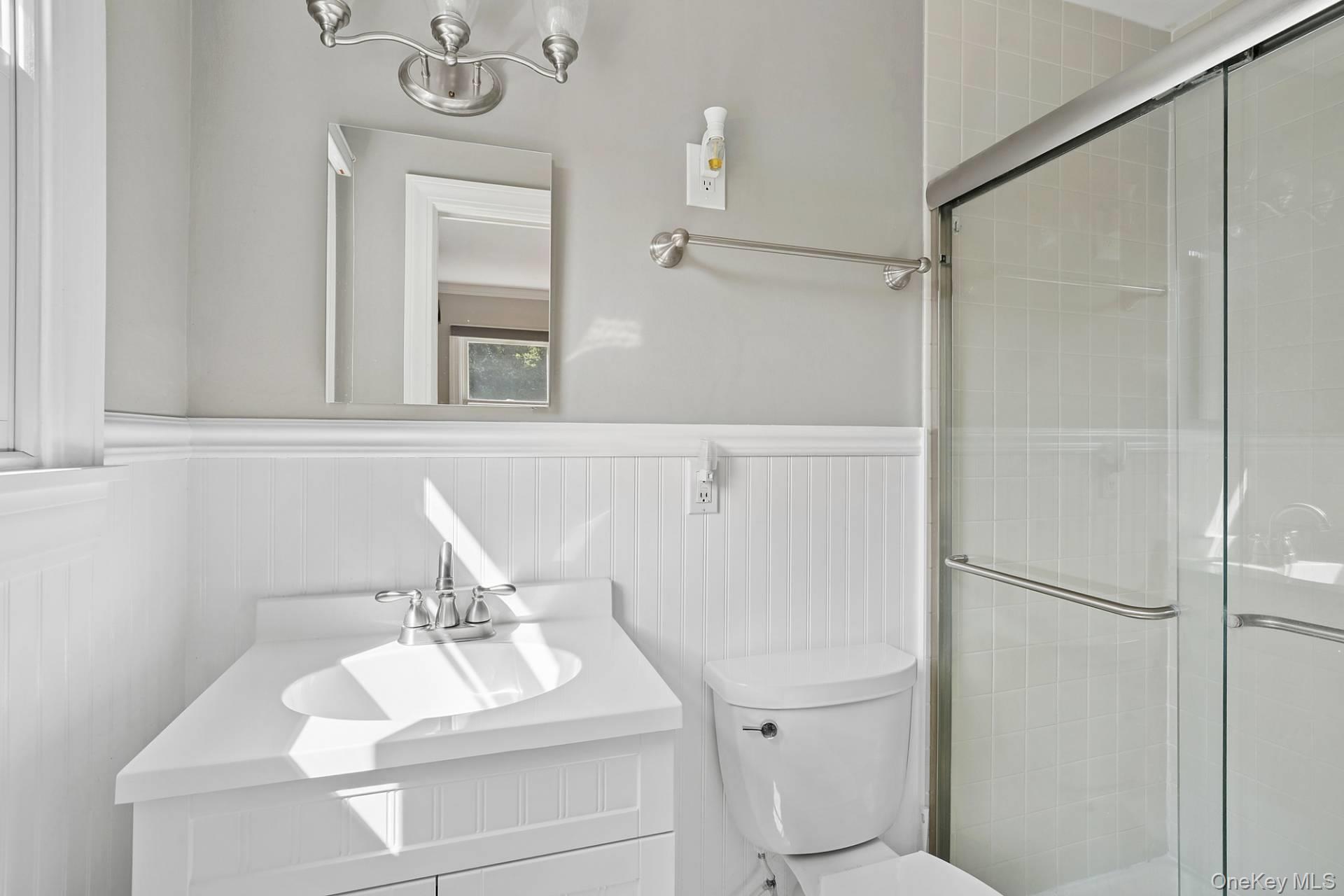 28 Plain View Drive Wading River, NY 11792 - Photo 7 of 20 a bathroom with a sink vanity mirror and toilet