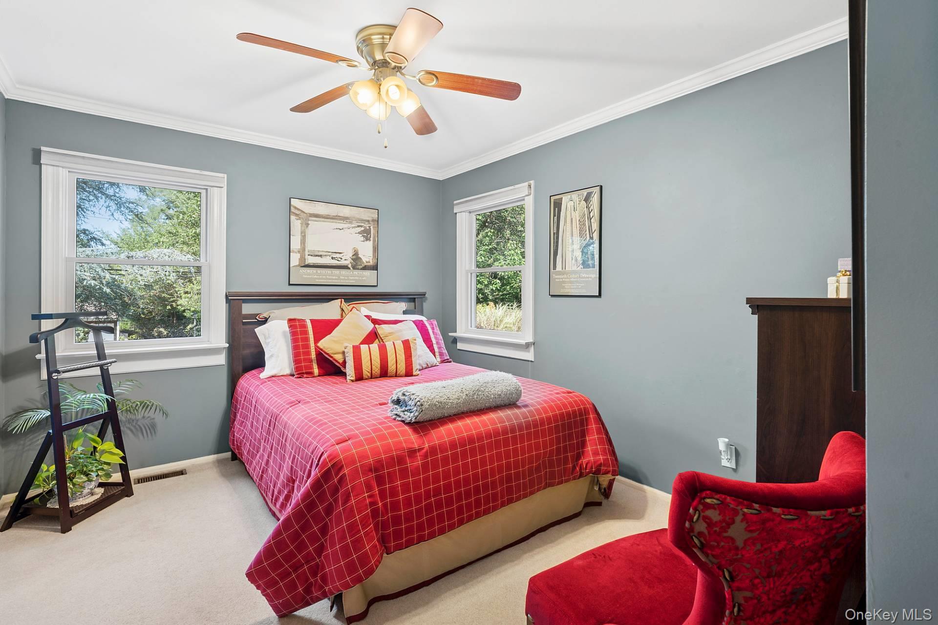 28 Plain View Drive Wading River, NY 11792 - Photo 10 of 20 a bedroom with a bed and a chandelier