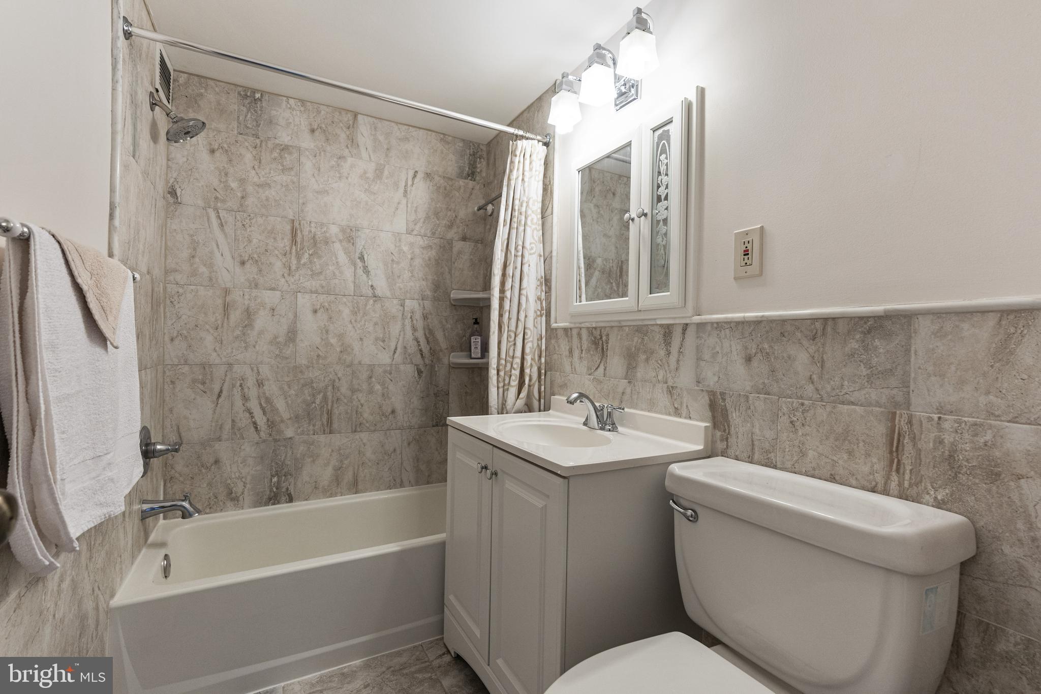 1300 South Arlington Ridge Road, Unit 402 Arlington, VA 22202 - Photo 14 of 23 a bathroom with a sink a toilet and shower
