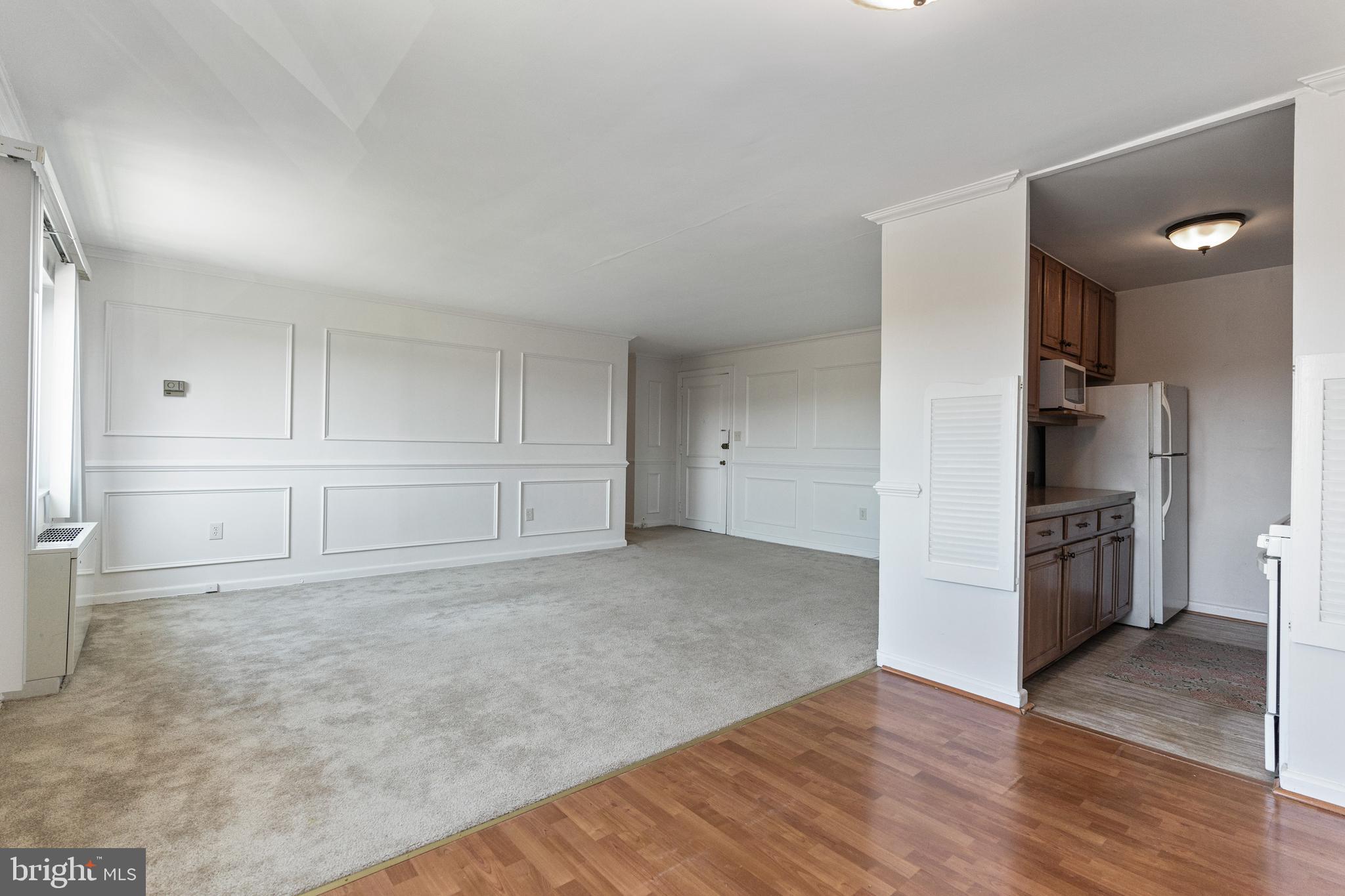 1300 South Arlington Ridge Road, Unit 402 Arlington, VA 22202 - Photo 2 of 23 a view of a kitchen with refrigerator and wooden floor