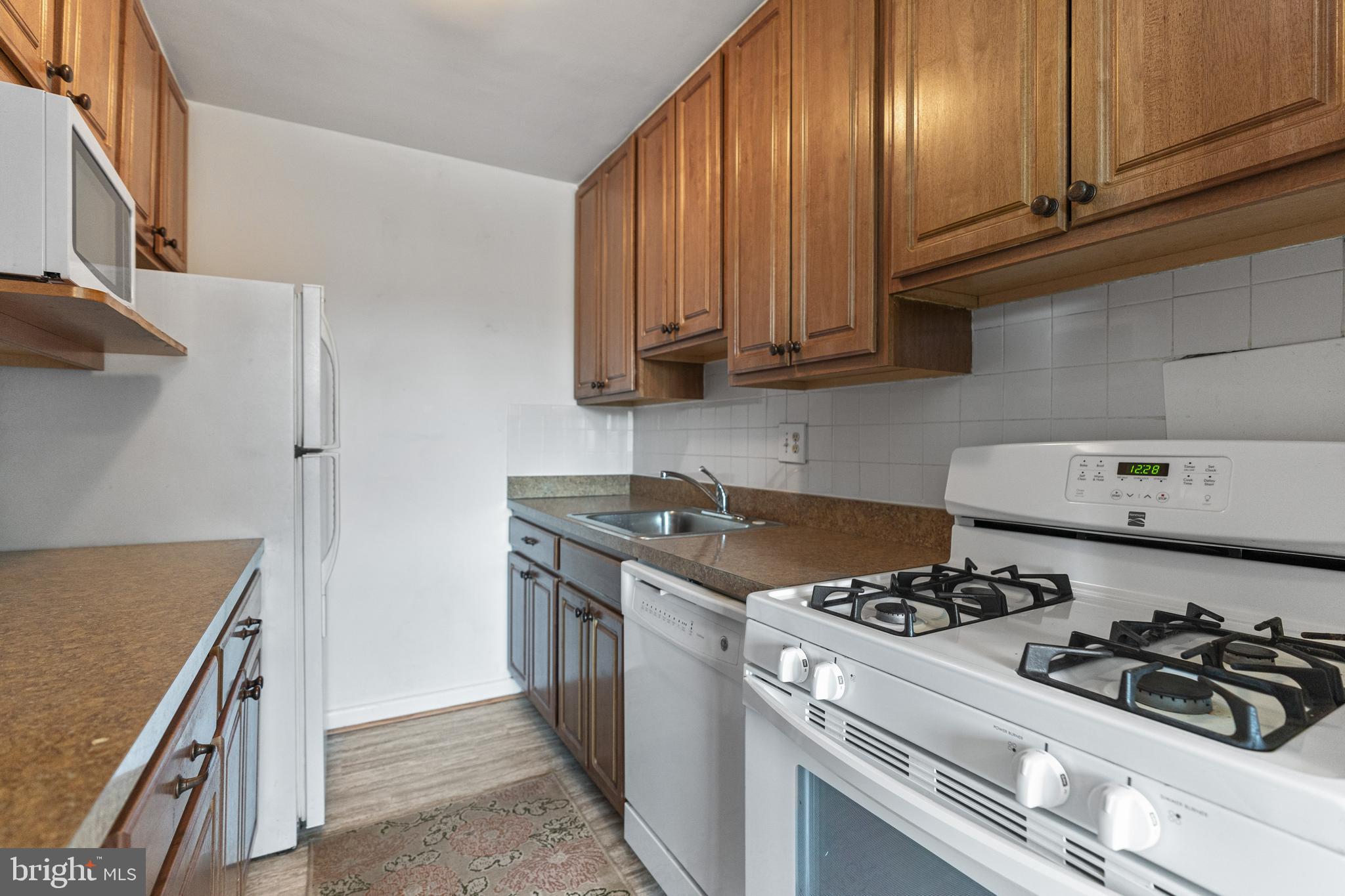 1300 South Arlington Ridge Road, Unit 402 Arlington, VA 22202 - Photo 5 of 23 a kitchen with a stove and a refrigerator