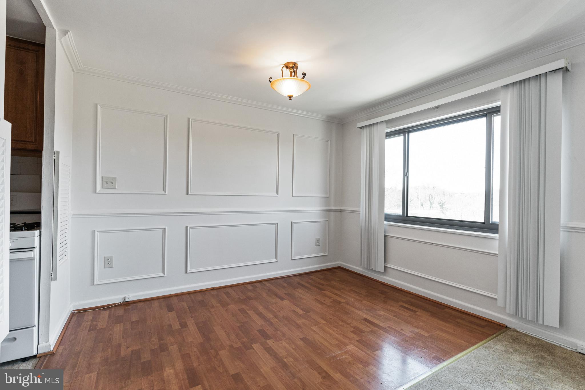 1300 South Arlington Ridge Road, Unit 402 Arlington, VA 22202 - Photo 6 of 23 an empty room with chandelier fan and windows