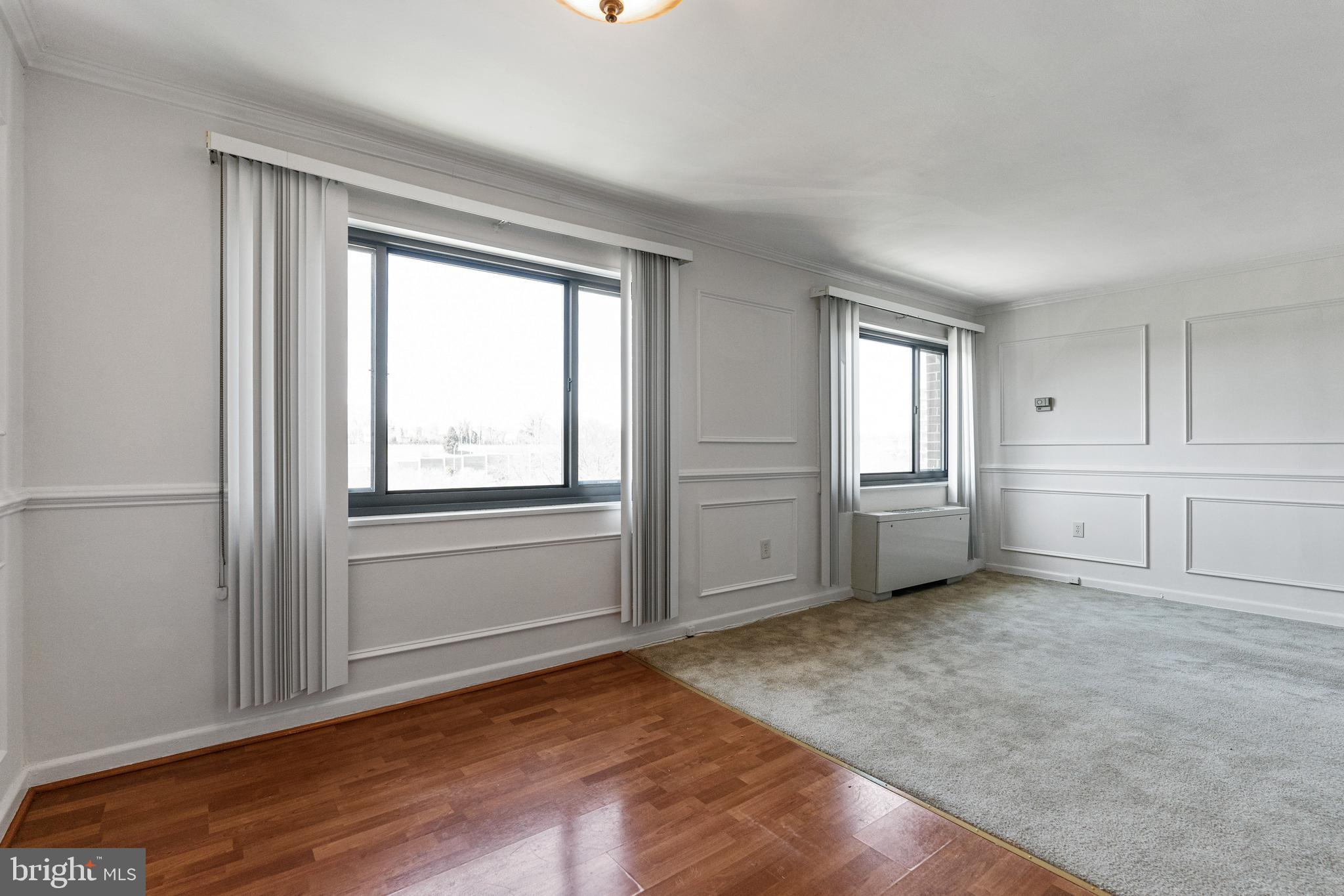 1300 South Arlington Ridge Road, Unit 402 Arlington, VA 22202 - Photo 7 of 23 an empty room with windows and cabinet