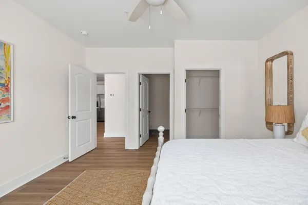 a bedroom with a bed and a chandelier