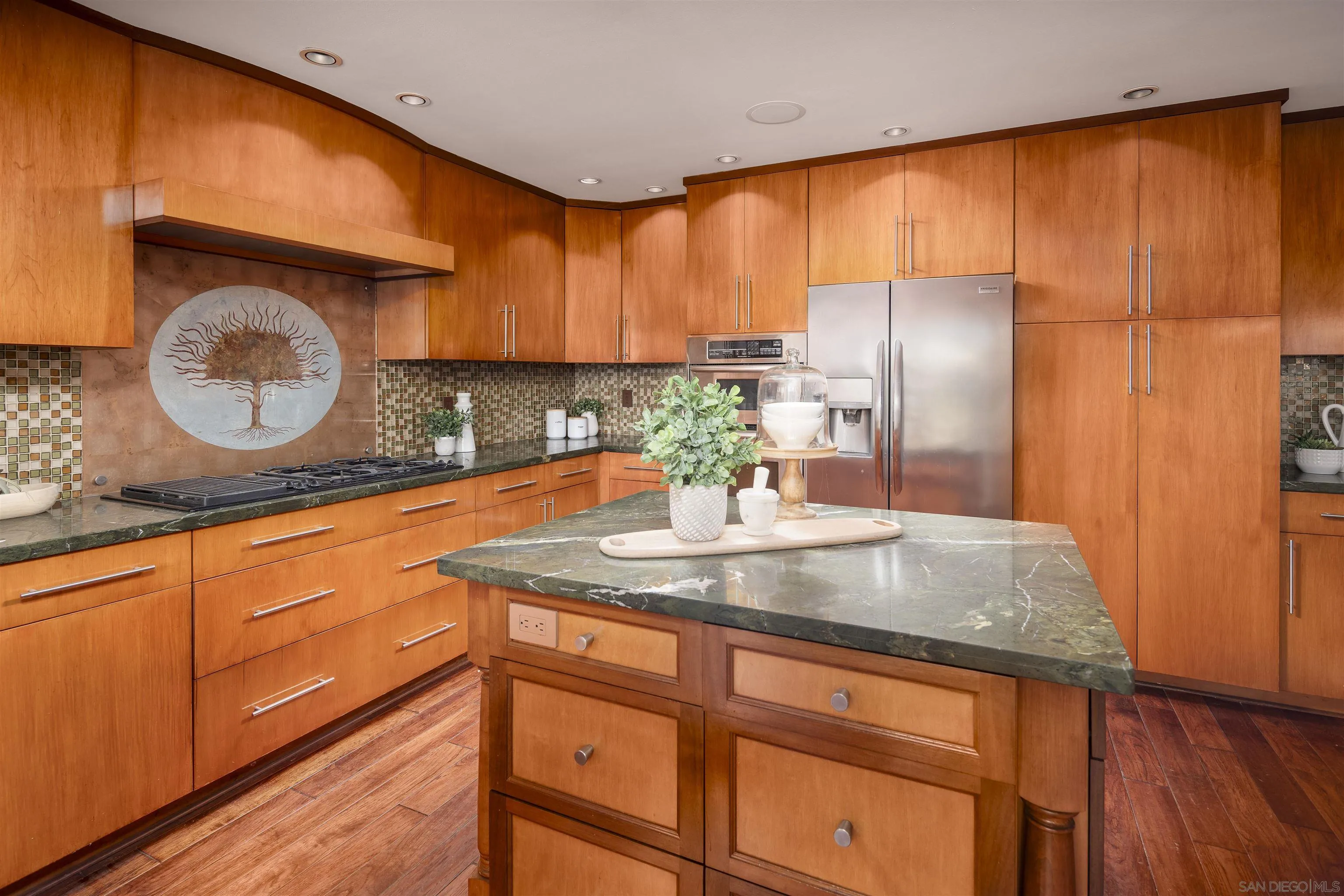 6129 La Flecha Rancho Santa Fe, CA 92067 - Photo 14 of 33 a kitchen with kitchen island granite countertop wooden cabinets and a large window