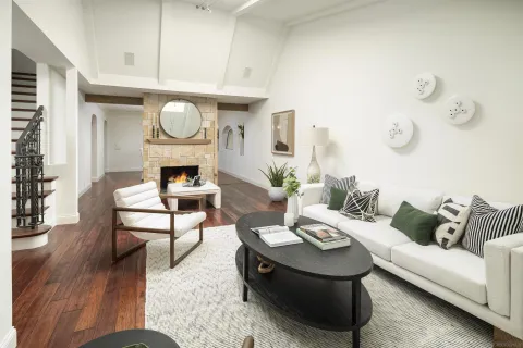 a living room with furniture a fireplace and a table