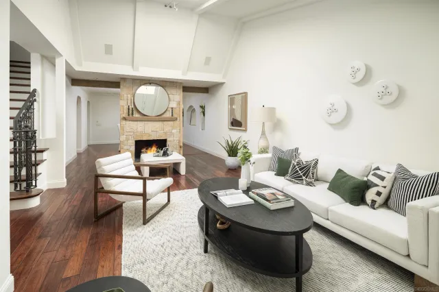 a living room with furniture a fireplace and a table