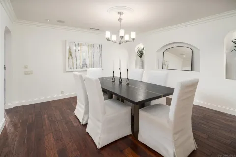 a view of a dining room with furniture wooden floor and chandelier