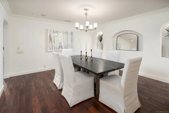 a view of a dining room with furniture wooden floor and chandelier