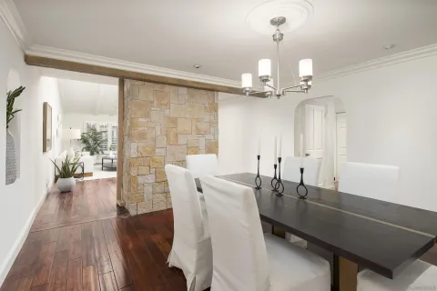 a view of a dining room with furniture and chandelier